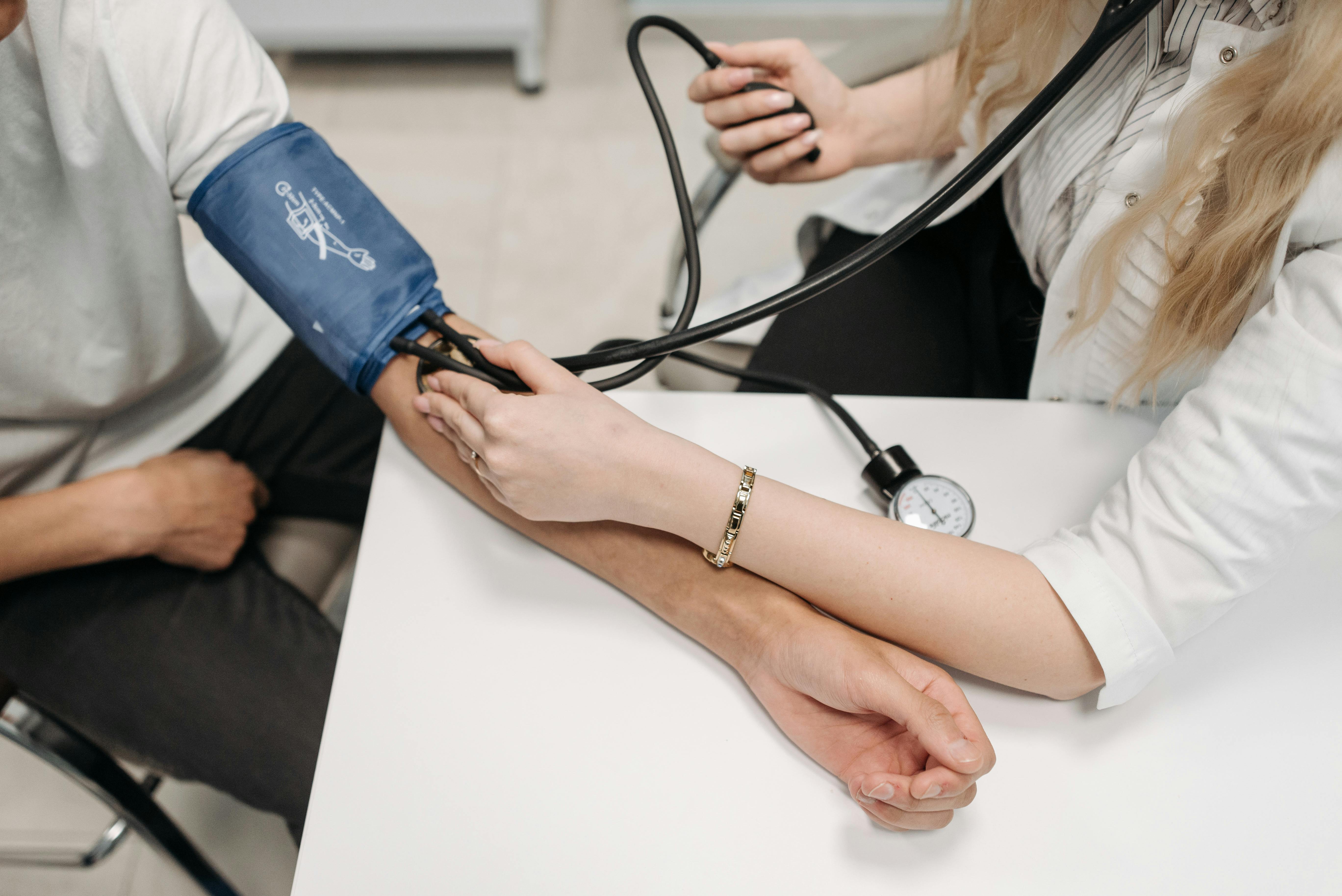 Patient having their blood pressure taken by a doctor